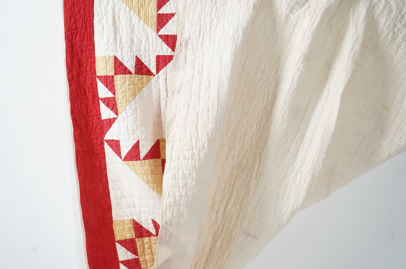 An early 1920’s-30’s American Virginian hand patch work, hand quilted bed cover. Called ‘Delectable Mountain Block’, worked in plain cottons of red, white and ochre, with a plain white backing and simple wadding. 182cm x